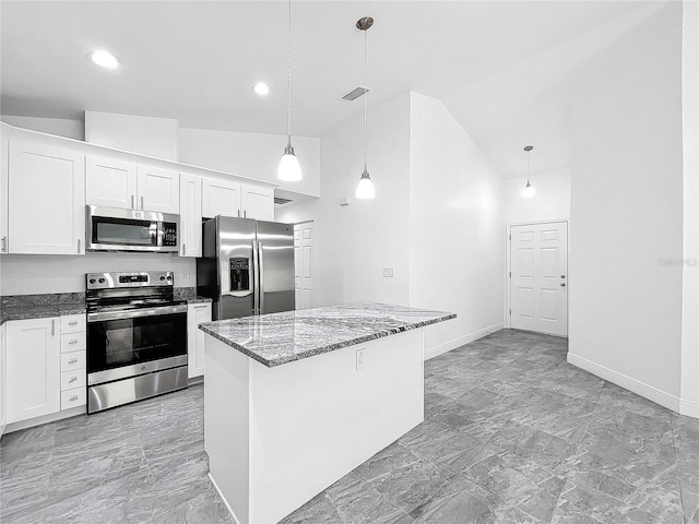 kitchen featuring hanging light fixtures, appliances with stainless steel finishes, white cabinets, and light tile patterned floors