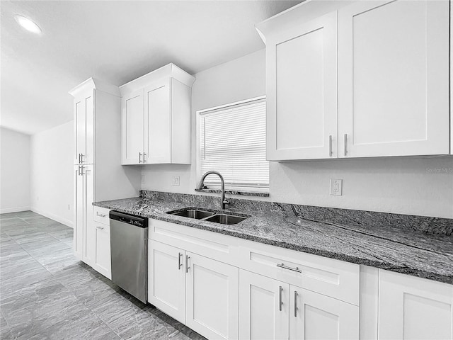 kitchen with light tile patterned floors, white cabinets, dishwasher, dark stone counters, and sink