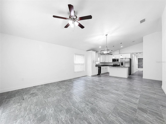 unfurnished living room featuring tile patterned flooring, ceiling fan with notable chandelier, and lofted ceiling