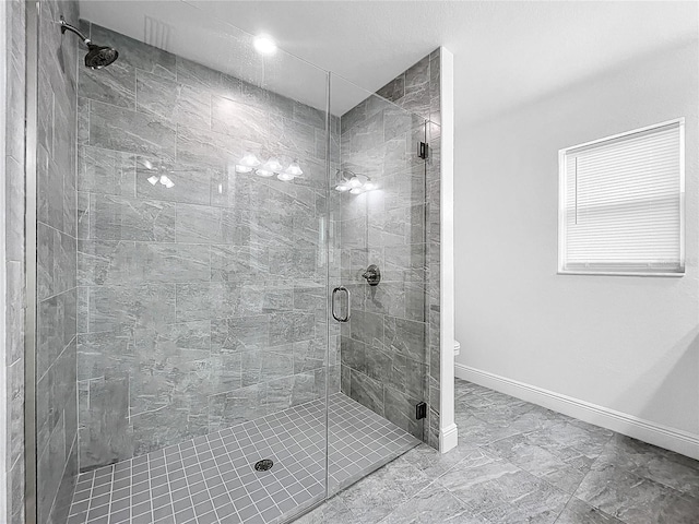 bathroom with walk in shower, tile patterned flooring, and toilet