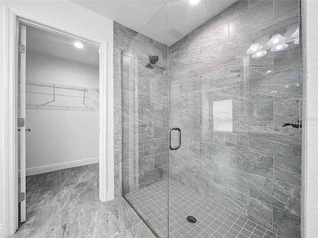 bathroom with an enclosed shower and tile patterned flooring