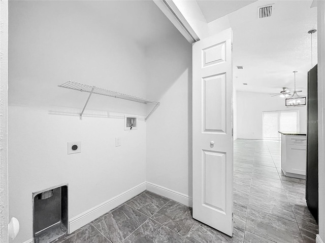 laundry area with electric dryer hookup, ceiling fan, dark tile patterned floors, and washer hookup