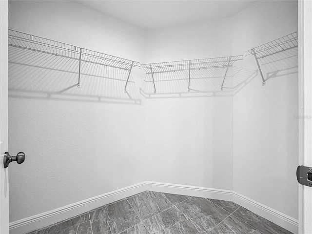 walk in closet featuring tile patterned flooring