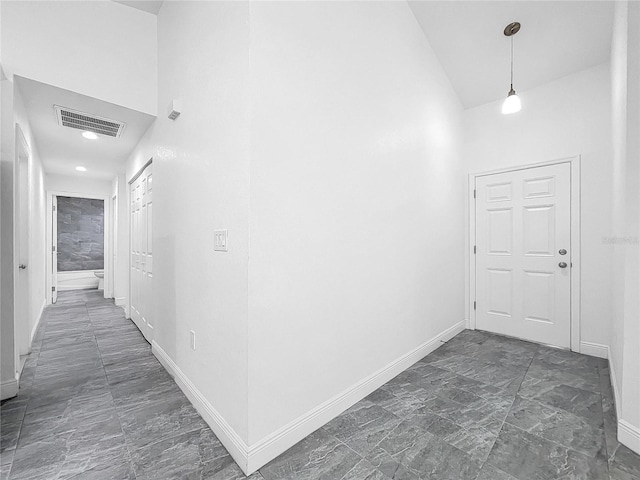 corridor featuring dark tile patterned floors