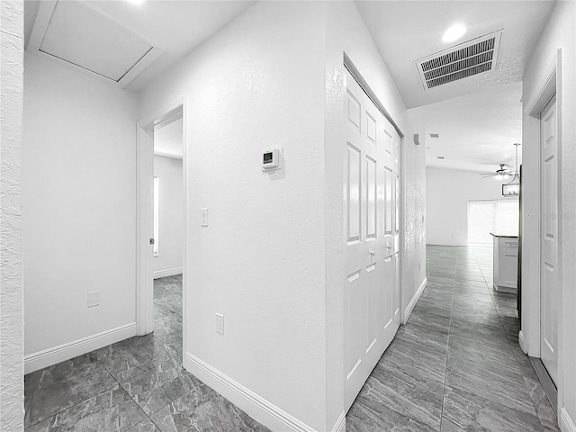 corridor with dark tile patterned floors