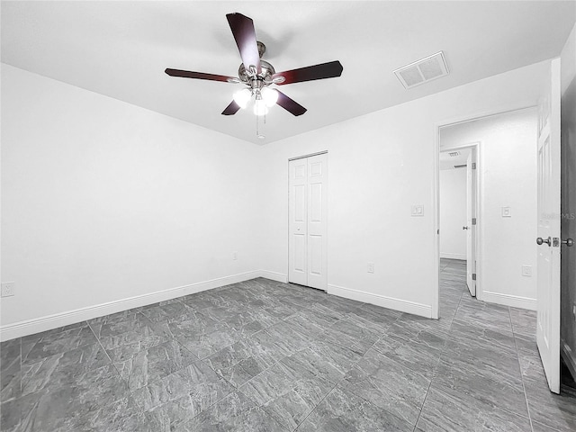 unfurnished bedroom featuring tile patterned floors, a closet, and ceiling fan