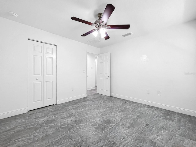 unfurnished bedroom featuring a closet, tile patterned floors, and ceiling fan