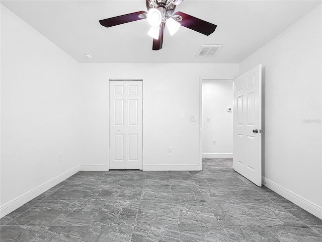 unfurnished bedroom featuring ceiling fan, tile patterned floors, and a closet