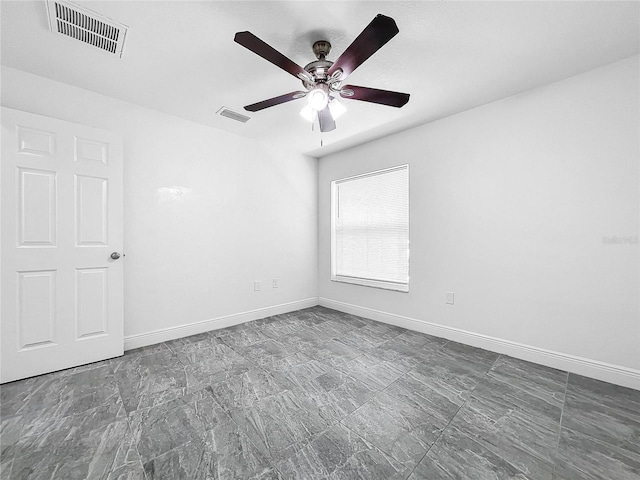 tiled empty room with ceiling fan