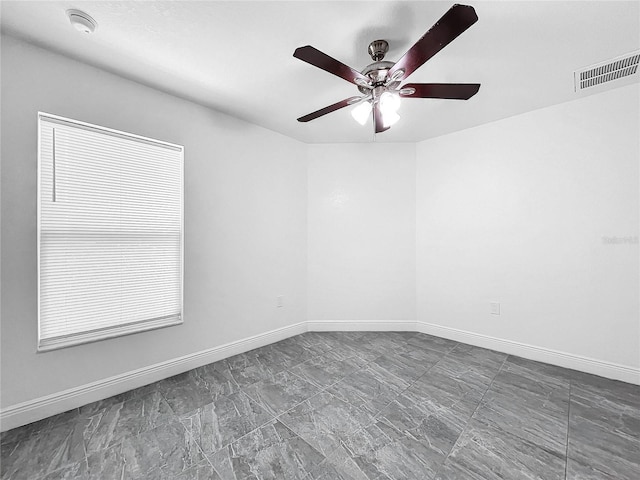 empty room with tile patterned floors and ceiling fan