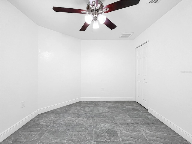 tiled empty room with ceiling fan