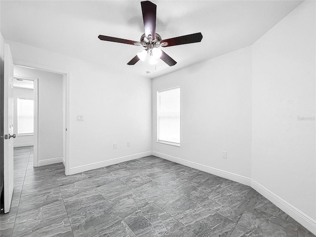 spare room featuring tile patterned flooring and ceiling fan