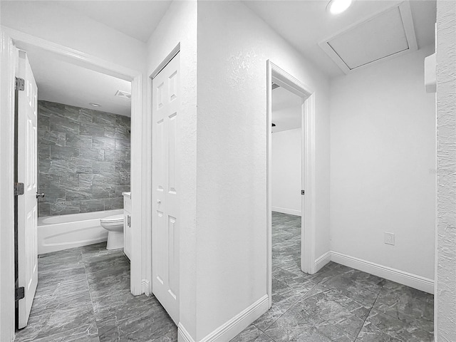 hallway featuring dark tile patterned flooring