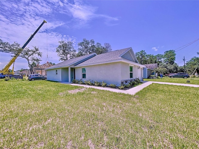 view of side of property with a lawn