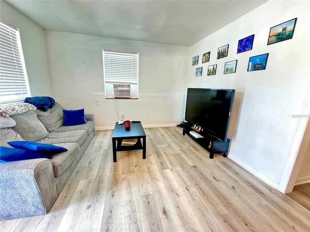 living room featuring cooling unit and light wood-type flooring