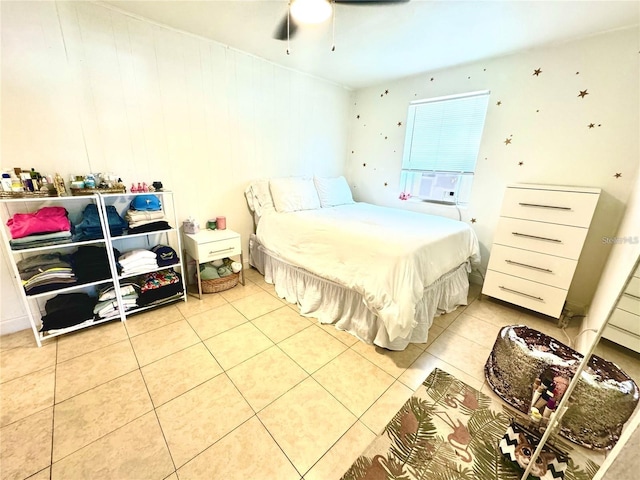 tiled bedroom featuring ceiling fan