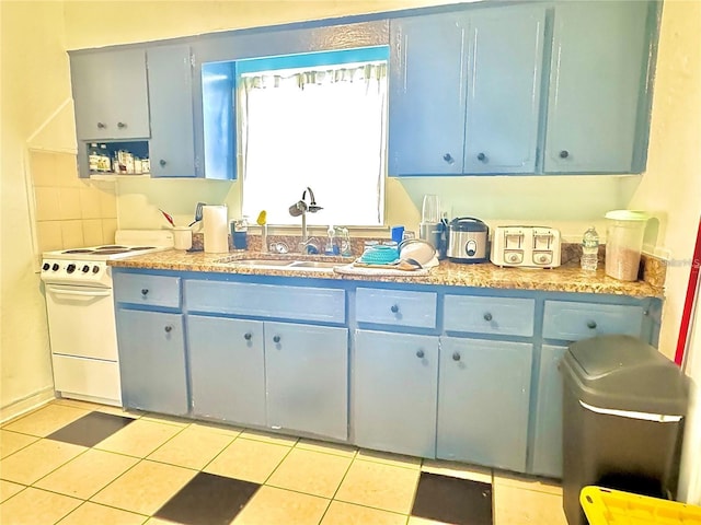 kitchen featuring blue cabinetry, white range with electric cooktop, sink, and light tile patterned floors