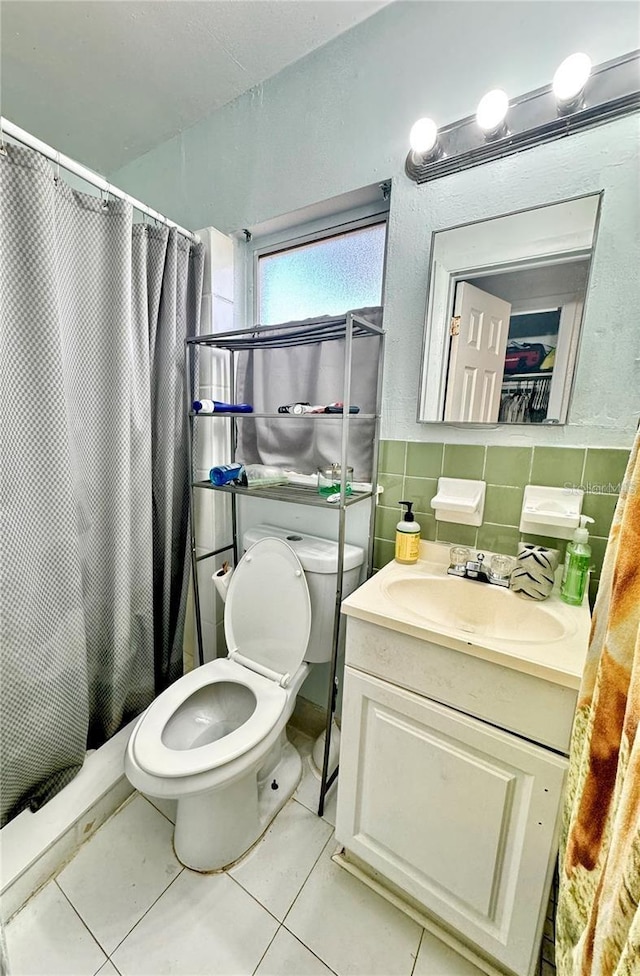 bathroom featuring tile patterned flooring, vanity, toilet, and a shower with shower curtain