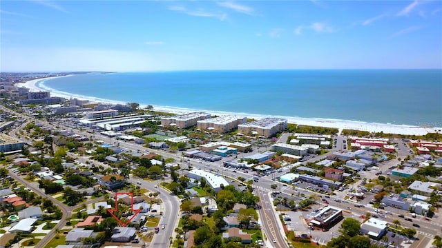 drone / aerial view featuring a water view and a beach view