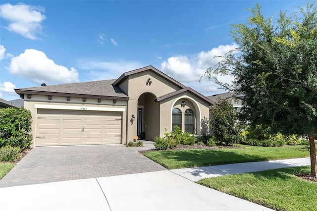 view of front facade with a garage and a front yard