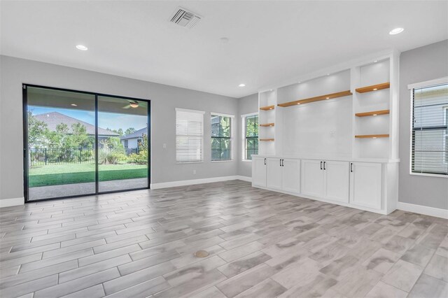 unfurnished living room with light hardwood / wood-style flooring