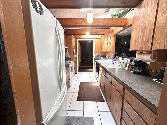 kitchen with sink, hanging light fixtures, light tile patterned floors, beamed ceiling, and white appliances