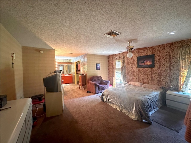 bedroom with ceiling fan, carpet, and a textured ceiling