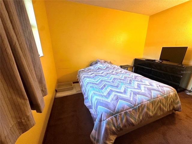 carpeted bedroom with a textured ceiling