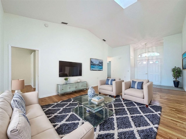 living room with hardwood / wood-style floors and vaulted ceiling