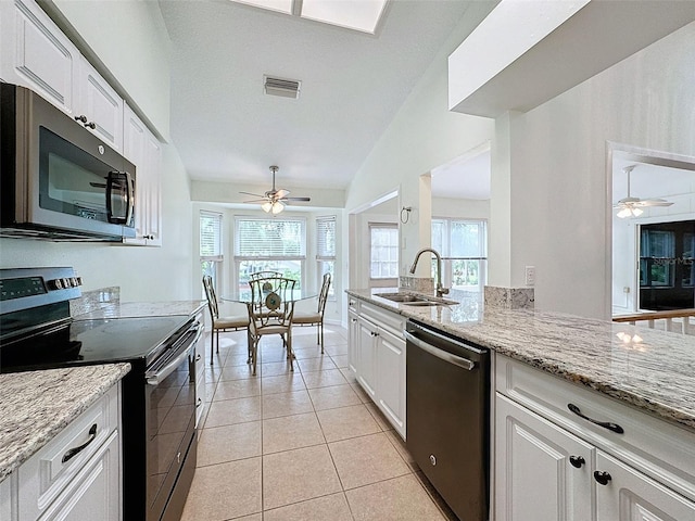 kitchen featuring light stone countertops, stainless steel appliances, white cabinetry, and sink