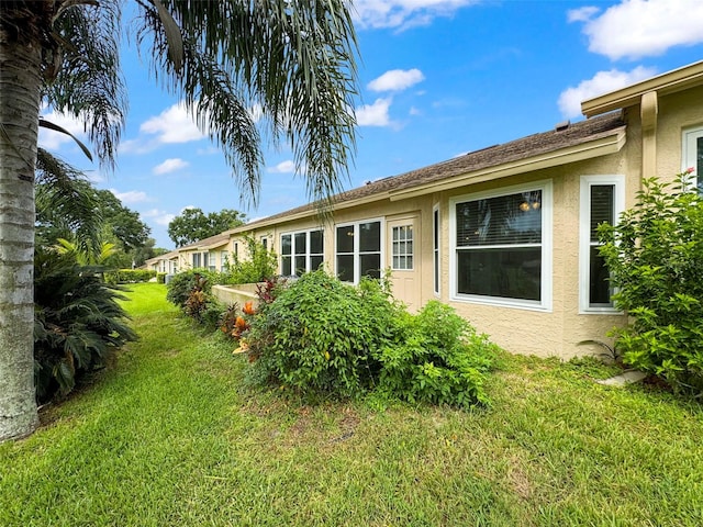 rear view of property featuring a lawn