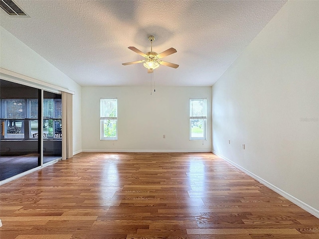 spare room featuring wood-type flooring, a textured ceiling, and ceiling fan