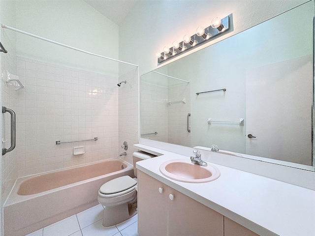 full bathroom with tiled shower / bath, tile patterned flooring, vanity, and toilet