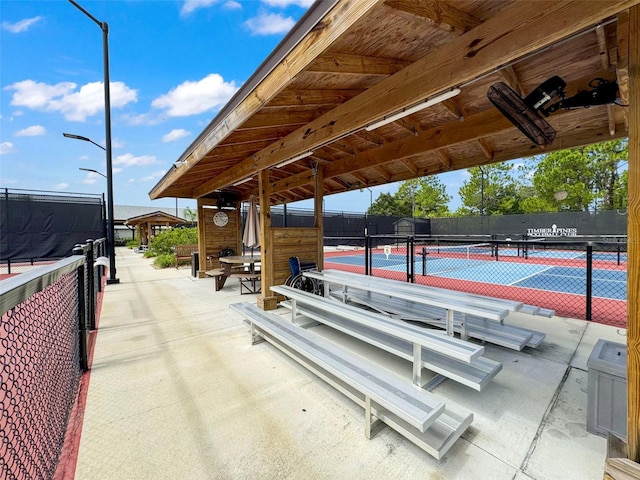 view of property's community featuring tennis court