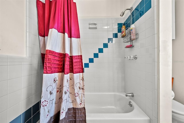 bathroom featuring toilet, shower / tub combo, and tile walls