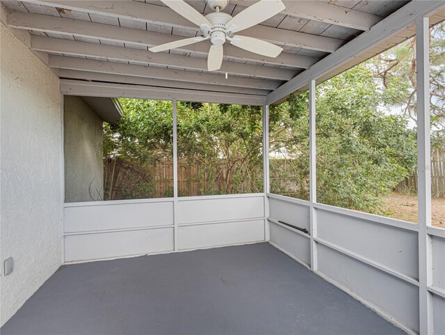 unfurnished sunroom featuring ceiling fan