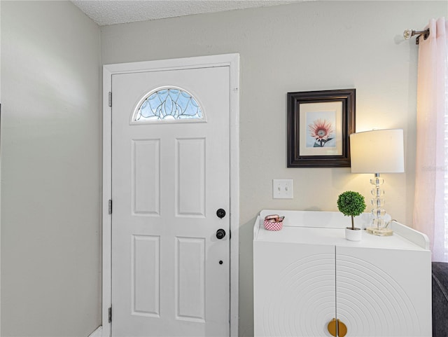 entrance foyer featuring a textured ceiling