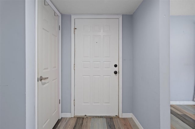 entryway featuring a textured ceiling and hardwood / wood-style floors