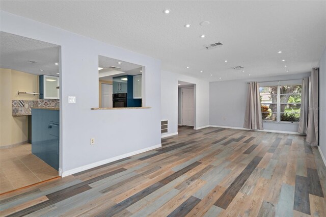 unfurnished living room with wood-type flooring