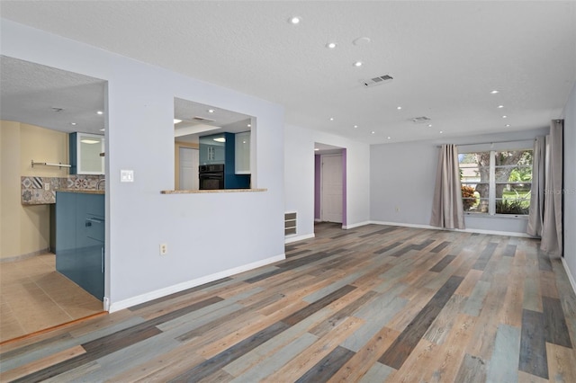 unfurnished living room with hardwood / wood-style flooring