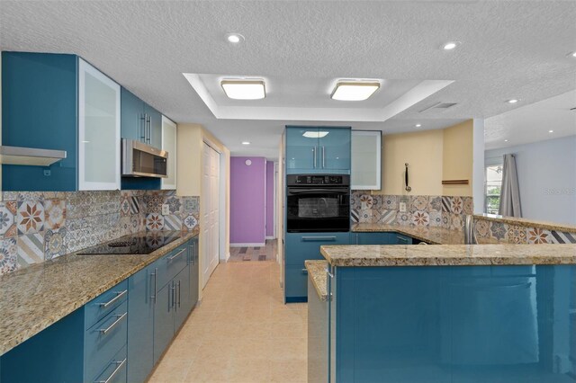 kitchen with black appliances, tasteful backsplash, blue cabinetry, a textured ceiling, and light tile patterned floors