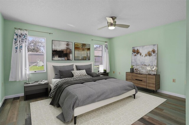 bedroom featuring ceiling fan, a textured ceiling, and dark hardwood / wood-style flooring