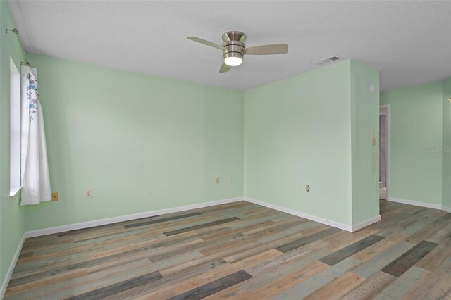 unfurnished room with wood-type flooring and ceiling fan