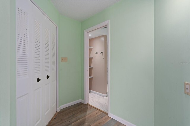 corridor featuring hardwood / wood-style flooring