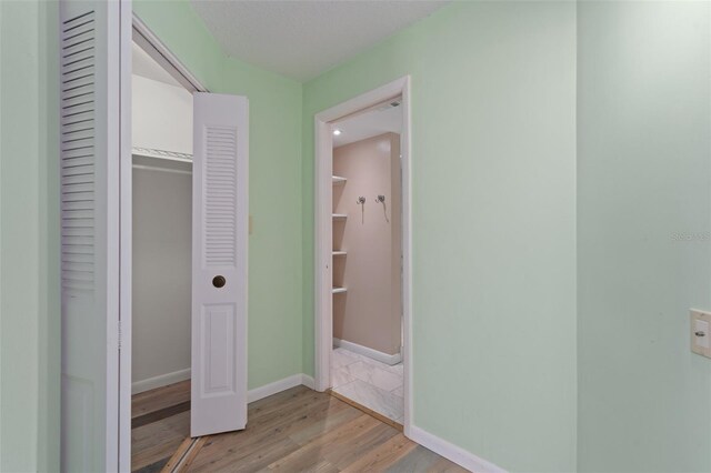 hallway with light hardwood / wood-style flooring