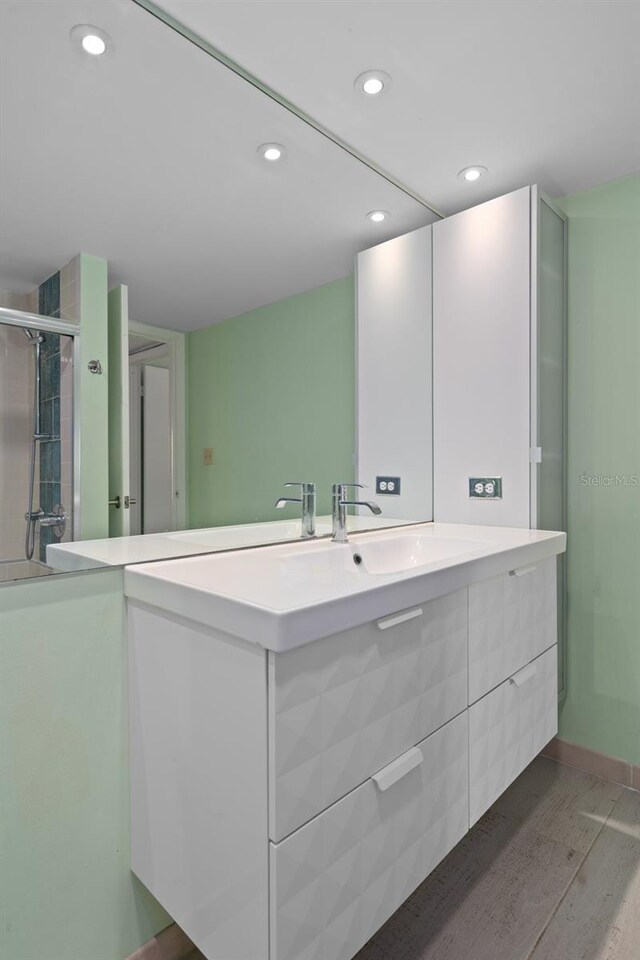 bathroom with wood-type flooring and vanity