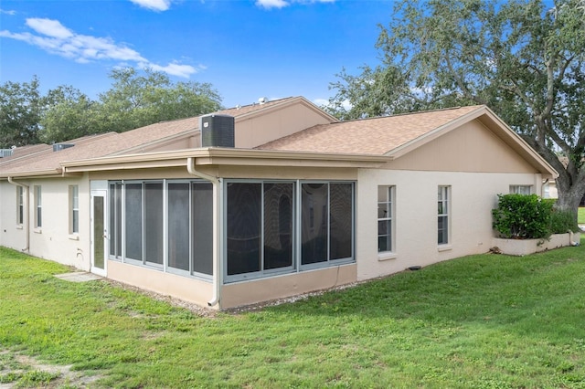 back of house with a sunroom and a yard