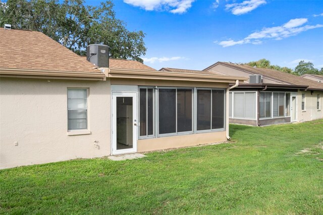 rear view of property featuring a lawn