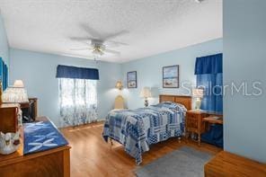 bedroom with hardwood / wood-style floors and ceiling fan