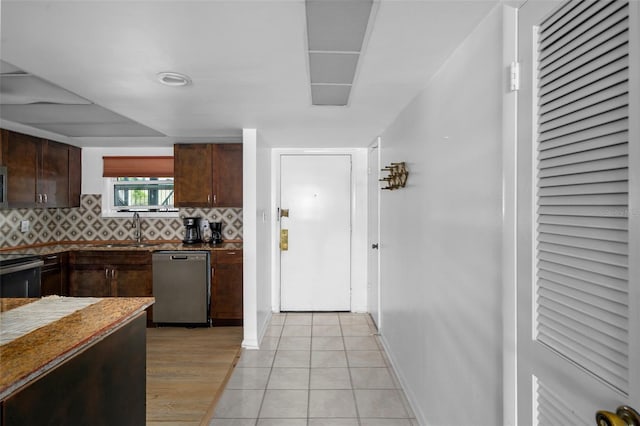 kitchen with tasteful backsplash, appliances with stainless steel finishes, sink, and dark brown cabinetry